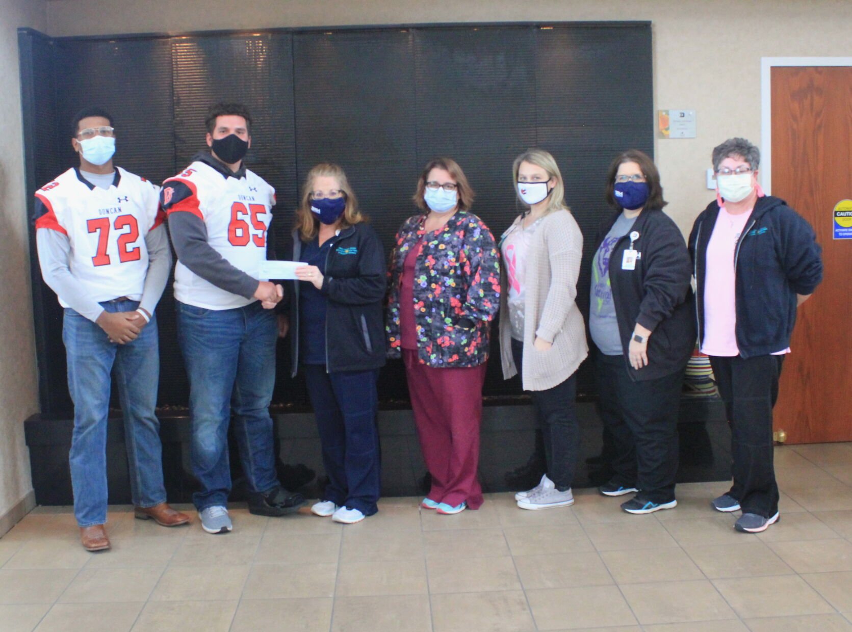 Wild art: Demons donate $500 to Cancer Center